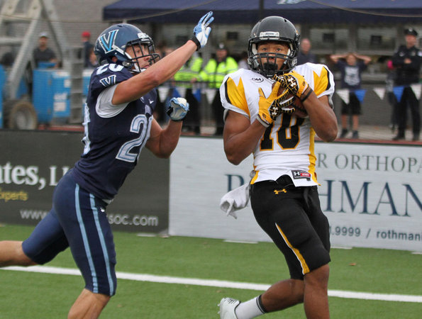 Towson's #10, Spencer Wilkins, right, hauls in a touchdown pass over Villanova's #20, Joe Sarnese during the second quarter. (Michael Bryant / Staff Photographer)