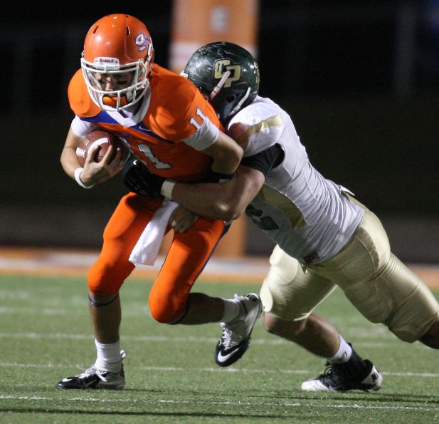 Sam Houston State quarterback Brian Bell (left) is sacked by Cal Poly's Chris Nicholls during the second half of a FCS college football playoff game, Saturday, December 1, 2012 at Bowers Stadium in Huntsville, TX.