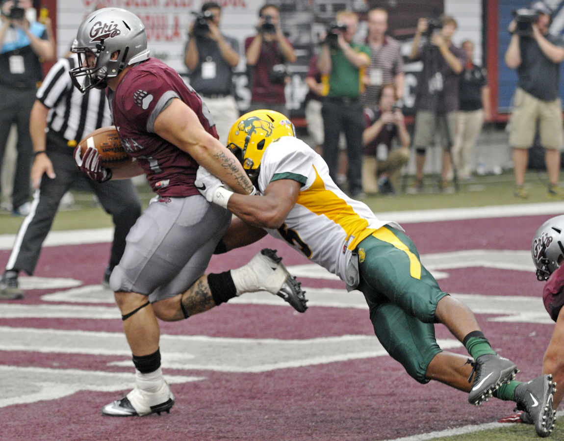 Montana running back Joey Counts runs the game-winning touchdown into the end zone as North Dakota State’s Jordan Champion attempts a tackle during the Grizzlies’ 38-35 victory on Saturday at Washington-Grizzly Stadium. The Grizzlies came from behind to win with 6 seconds left in the game in front of a record crowd.